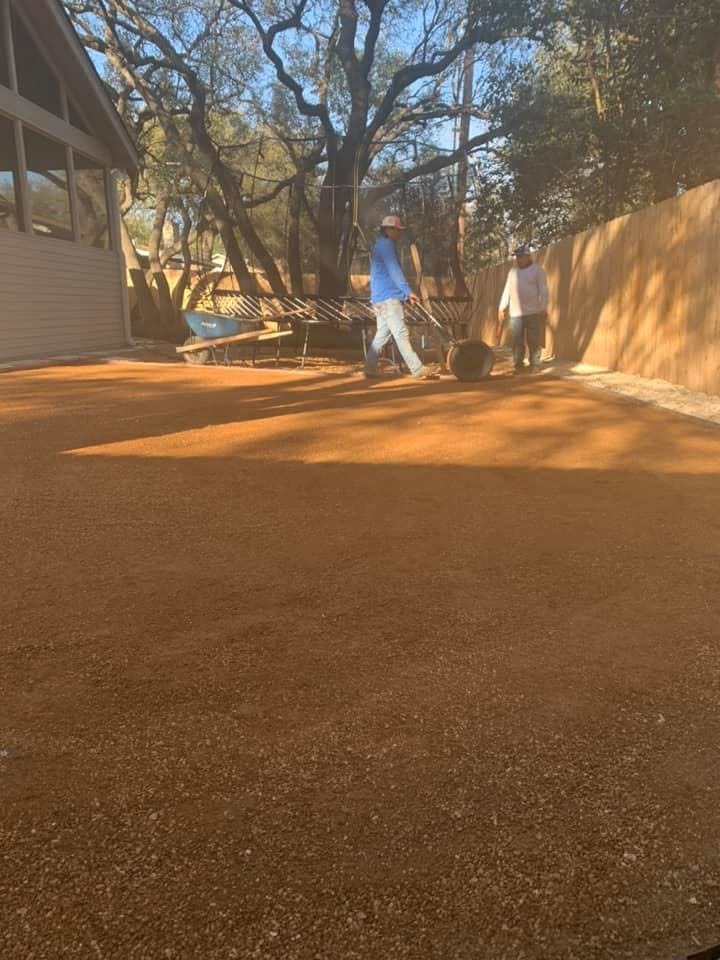 Crew preparing the backyard base beside a screened porch and trampoline